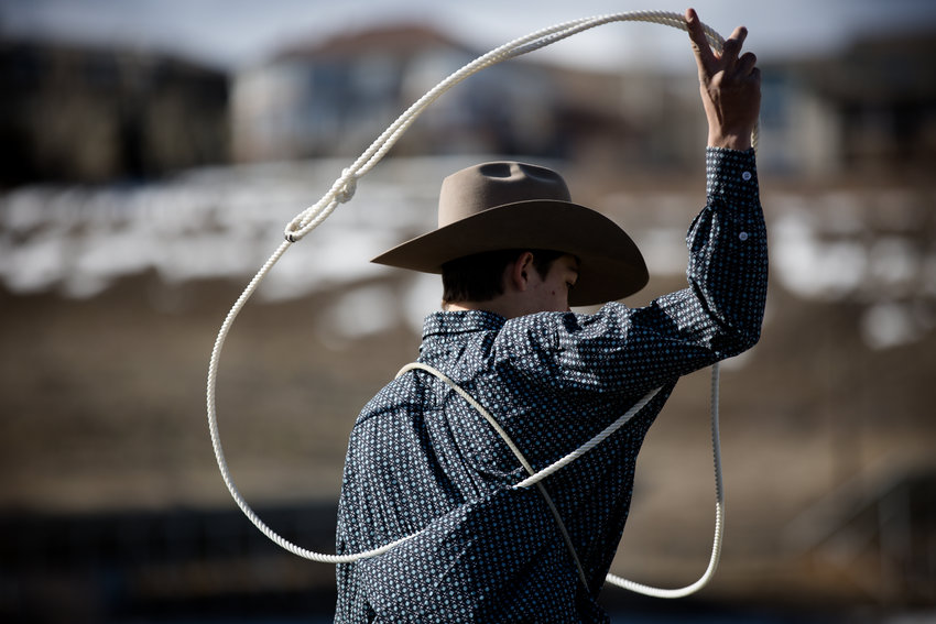 Trent Johnson practices his roping outside the arena as he waits for his events to start.